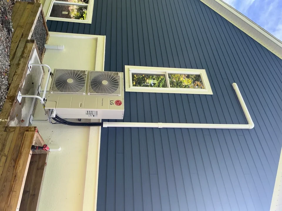 LG unit on dark blue house with line set