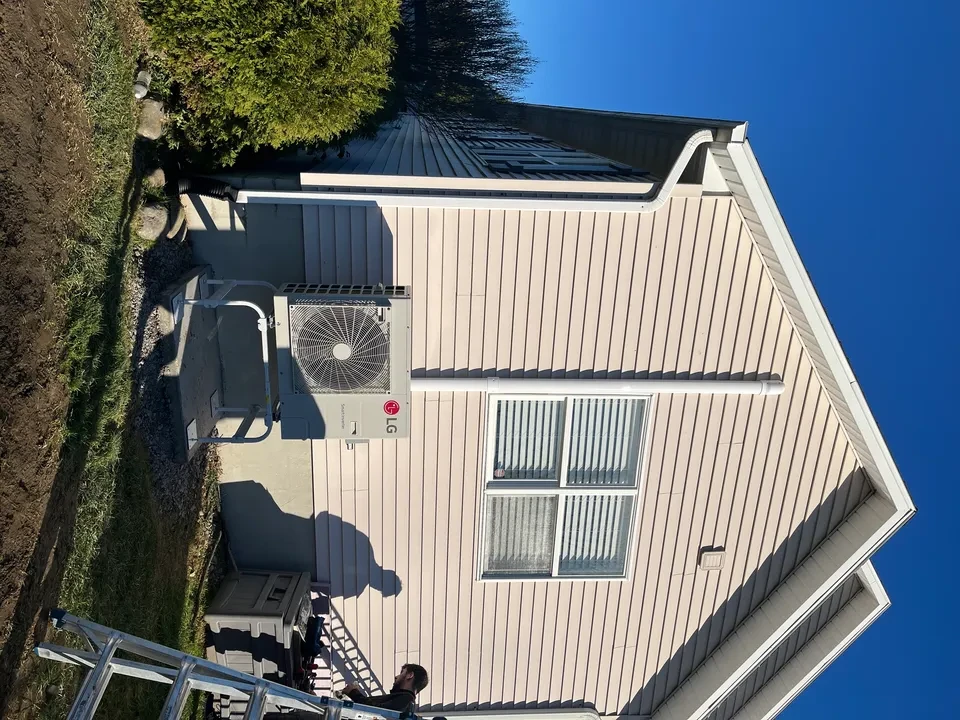 LG unit on tan house with blue sky